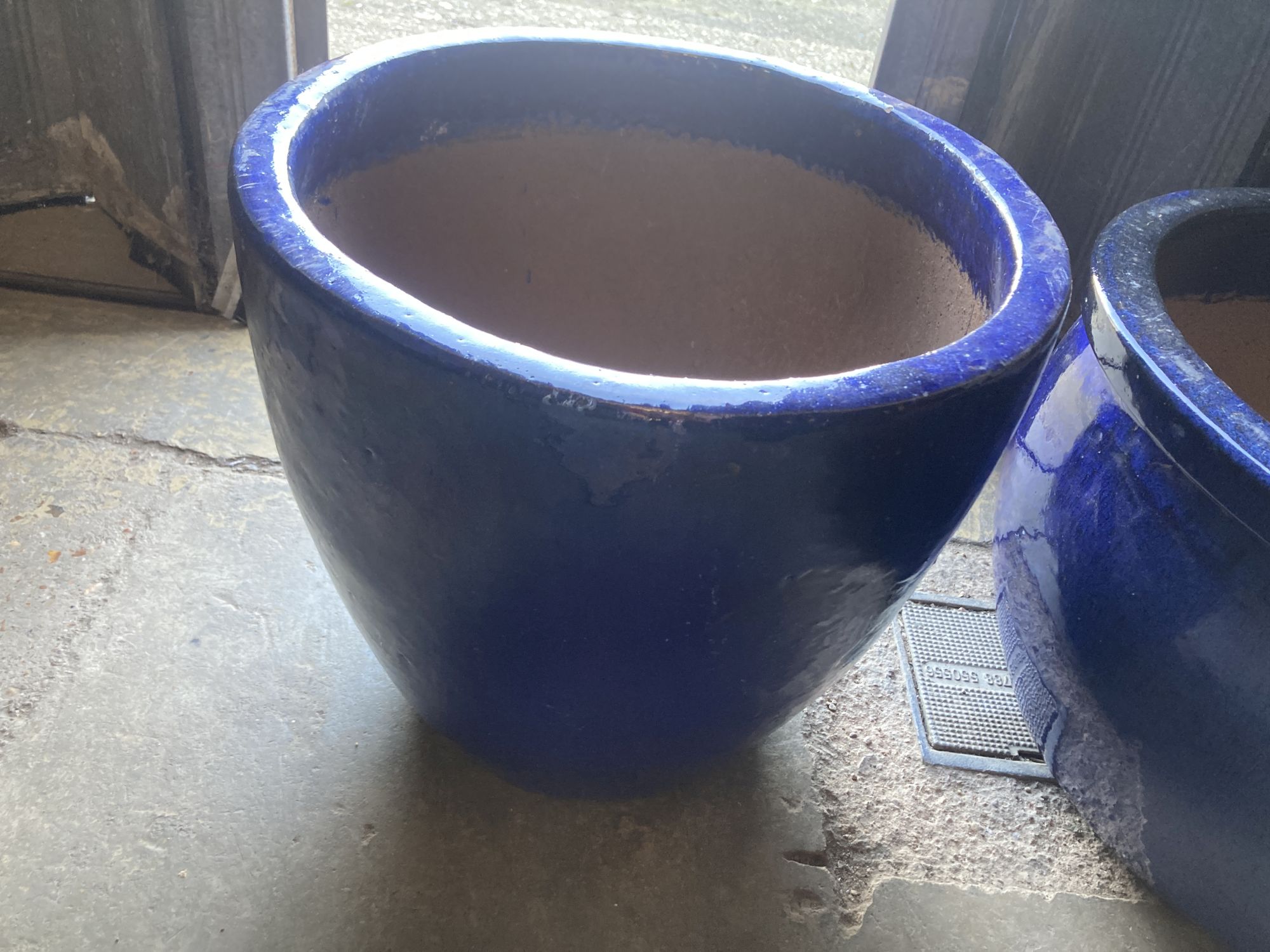 Two circular blue glazed garden planters, larger 50cm diameter, 30cm high